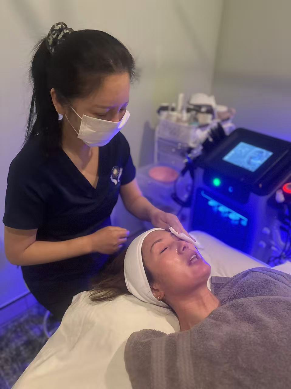 Esthetician performing detailed facial care